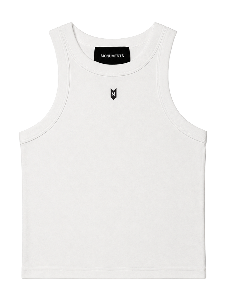 MONUMENTS MM cropped tank top in white cotton-spandex with a black MONUMENTS neck tab and MM chest mark, front view.