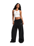 Model wearing the MONUMENTS MM cropped tank top in white cotton-spandex.