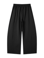 Back of the MONUMENTS structured wide-leg sweatpants in black heavyweight cotton-blend fleece.