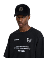 MONUMENTS six-panel corduroy hat in black with embroidered MM monogram.