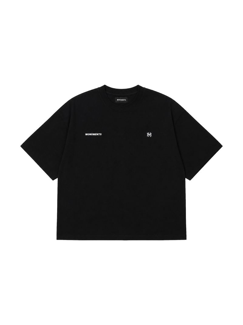 MONUMENTS MM core logo cropped boxy tee in black cotton with embroidered MM front artwork, front view.