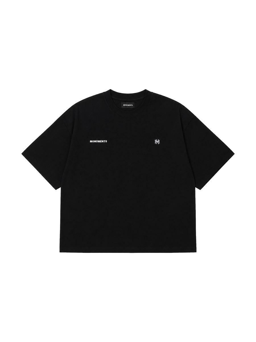MONUMENTS MM core logo cropped boxy tee in black cotton with embroidered MM front artwork, front view.