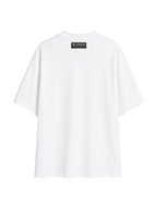 Back of the white MONUMENTS 414 Structure oversized tee showing the woven MONUMENTS label.